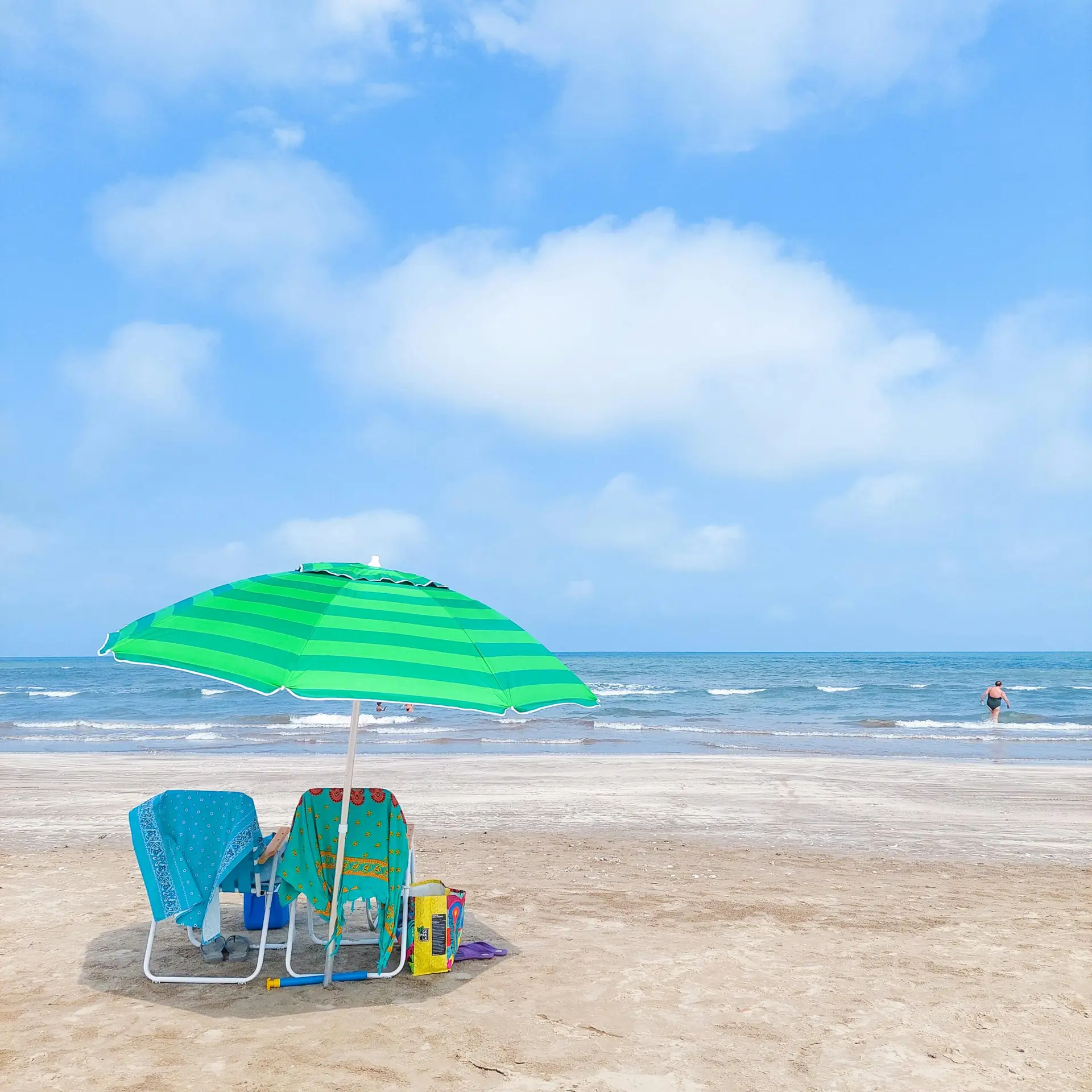 Chairs and umbrella on Cassino Beach, Brazil, capturing a serene summer day.